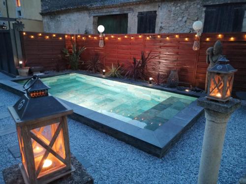 a swimming pool with lights and a fence at _Linstant_zen_ in Saint-Just