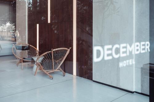 two chairs sitting in front of a store window at December Hotel in Nha Trang
