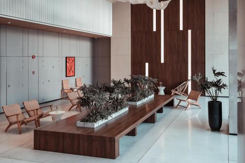 a lobby with a row of benches with plants at December Hotel in Nha Trang