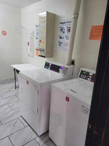a kitchen with white appliances in a room at Super 8 by Wyndham Portage in Portage