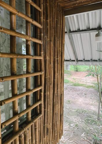 a bamboo wall in a building with a window at The Forest - Sell the Experience in Pai