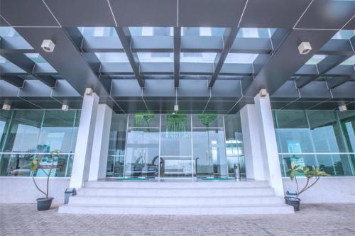 an office building with stairs and glass windows at The Enviro Nusantara By Reccoma in Cibeber