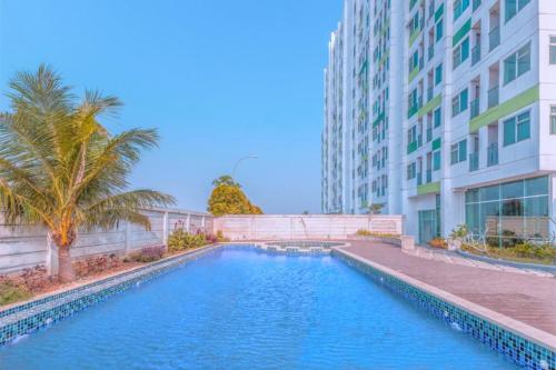 a swimming pool in front of a building at The Enviro Nusantara By Reccoma in Cibeber