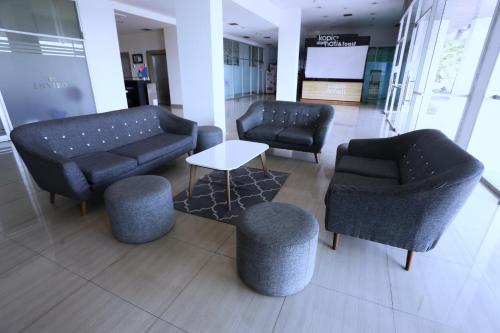 a lobby with couches and chairs and a table at The Enviro Nusantara By Reccoma in Cibeber