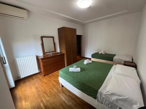 a bedroom with a bed and a dresser and a mirror at Marconi Rooms and Apartments in Verona