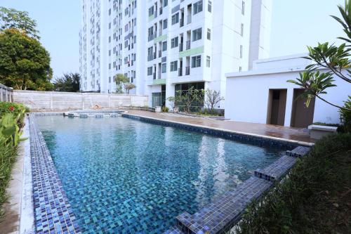 a swimming pool in the middle of a building at The Enviro Nusantara By Reccoma in Cibeber