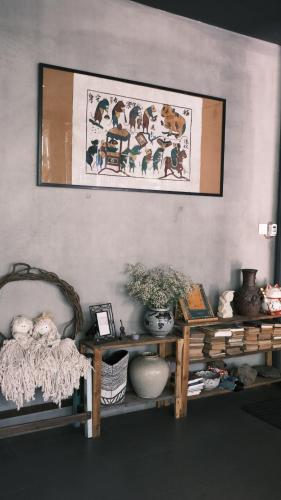a room with a table and a picture on the wall at La Maison Des Délices in Da Nang