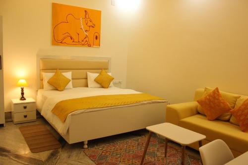 a bedroom with a bed and a couch at The Nandi International Boutique Stay in Varanasi