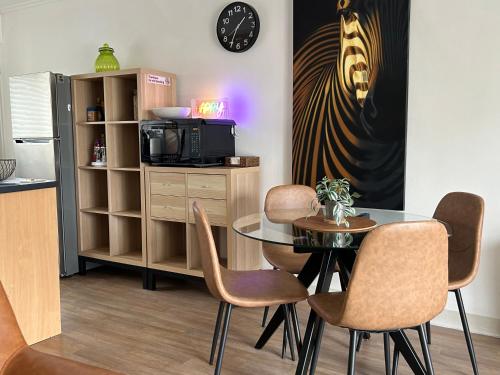 a dining room with a glass table and chairs at Sunshine Seven in Salisbury