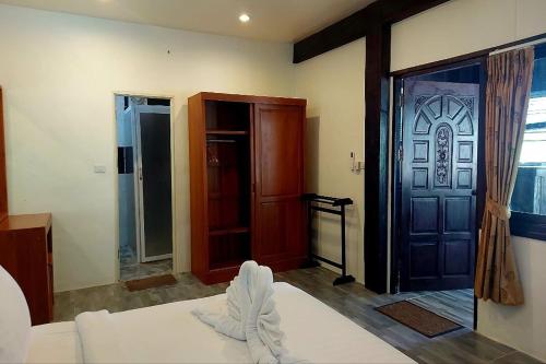 a living room with a bed and a door at Suanmali Samui in Lamai