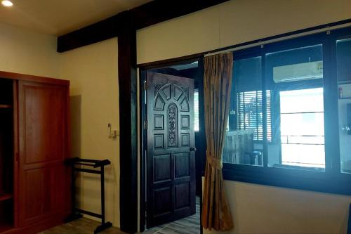 a door in a room with a window and a curtain at Suanmali Samui in Lamai