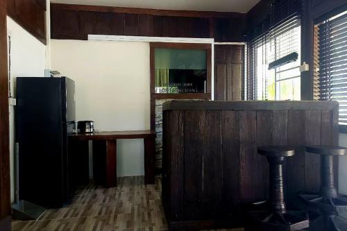 a room with a counter and a table and a refrigerator at Suanmali Samui in Lamai
