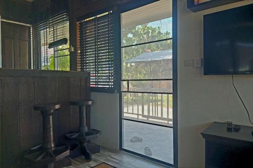 a room with a window with a view of a balcony at Suanmali Samui in Lamai