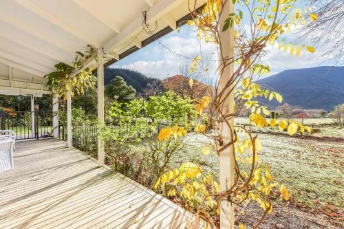 a porch with a view of a mountain at Fantail House Kaiuma Bay - Havelock Holiday Home in Havelock