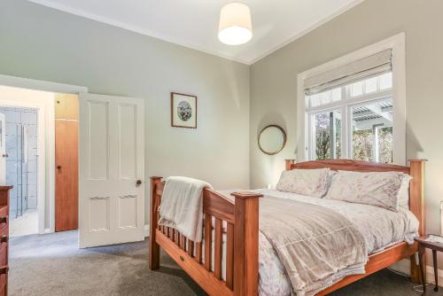 a bedroom with a bed and a window at Fantail House Kaiuma Bay - Havelock Holiday Home in Havelock