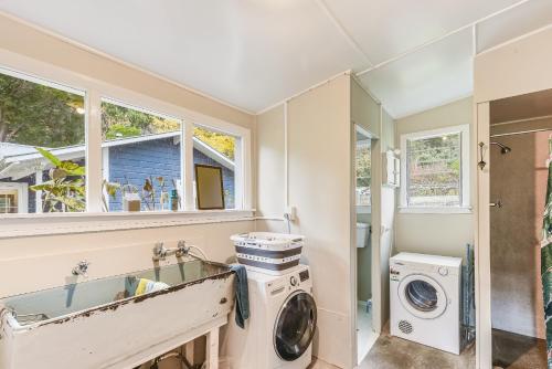 a laundry room with a washer and dryer at Fantail House Kaiuma Bay - Havelock Holiday Home in Havelock