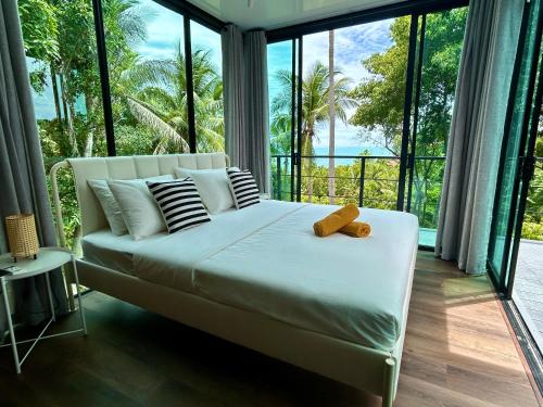 a bedroom with a bed with a teddy bear on it at Kalani, Haad Yao in Haad Yao
