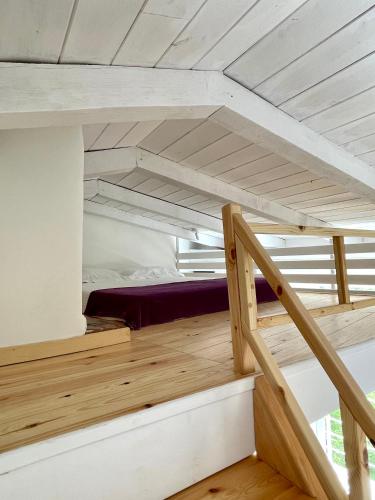 a room with a bunk bed and a staircase at Mare Monte Small Boutique Hotel in Chrysi Ammoudia