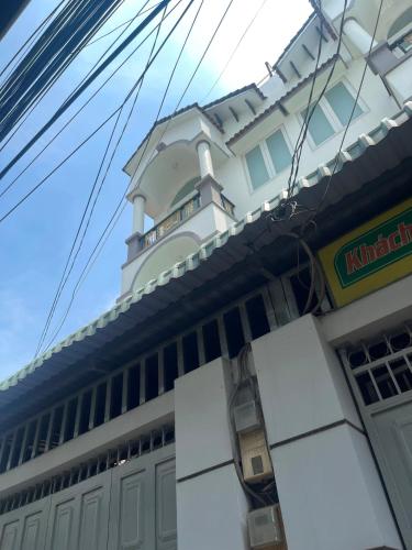 a building with a clock tower on top of it at Nguyên Thanh Hotel in Ho Chi Minh City