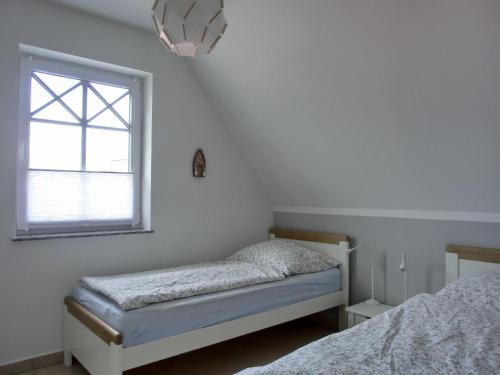 Postel nebo postele na pokoji v ubytování Ferienhaus FH T 1b
