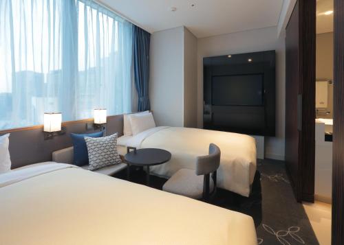 Ένα ή περισσότερα κρεβάτια σε δωμάτιο στο Hotel Gracery Seoul
