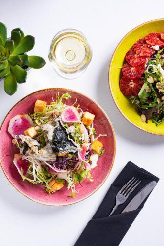 a table with two plates of food and a salad at Holiday Inn Toronto International Airport by IHG in Toronto