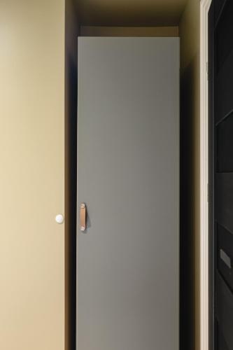 a white door with a handle in a room at Bryggen // Fløyen Living in Bergen