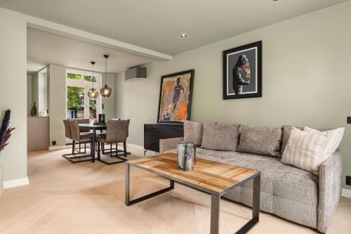 a living room with a couch and a table at Bryggen // Fløyen Living in Bergen
