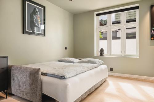 a bed in a room with a window at Bryggen // Fløyen Living in Bergen