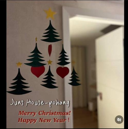 a decal of christmas trees on a wall at Juns House 대인원 수용 가능, 2층 복층 주택, 테라스보유, 가족숙소 적합 in Pohang
