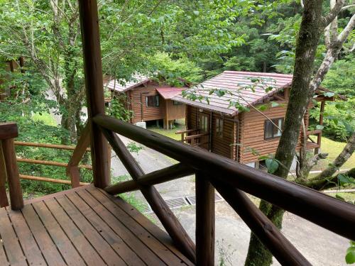 a view from the deck of a cabin in the woods at Nature Resort in Shimanto in Funato