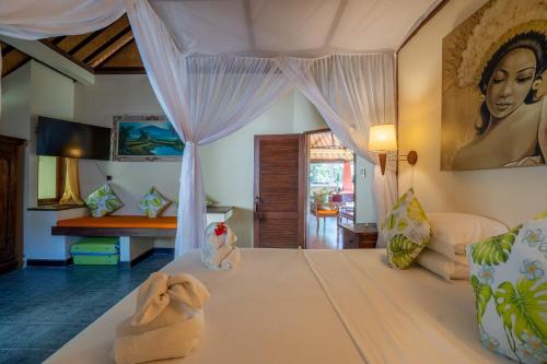 a bedroom with a bed in a room at Taman Sari Bali Resort and Spa in Pemuteran