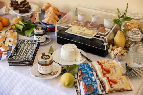 a table topped with plates of food and desserts at Scario Club in San Giovanni a Piro