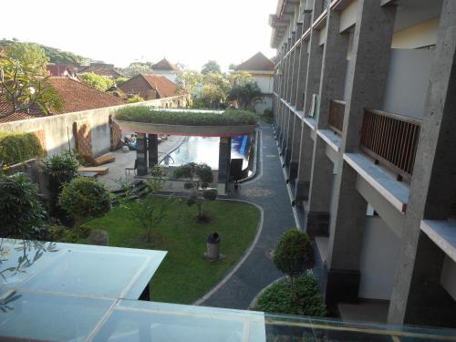 a view of a courtyard from a balcony of a building at Grand Sinar Indah in Legian
