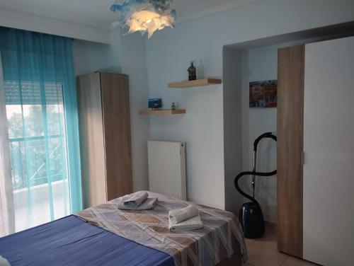 a bedroom with a bed and a window at Ester's Sea Side apartment in Neoi Epivates