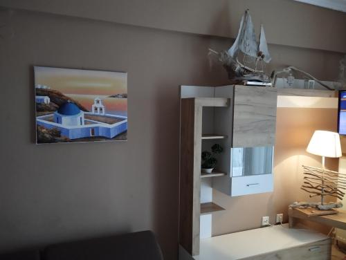 a living room with a picture on the wall at Ester's Sea Side apartment in Neoi Epivates