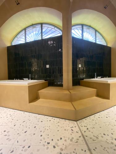 a lobby with two sinks and a large window at La dimora di Don Antonio in Matera