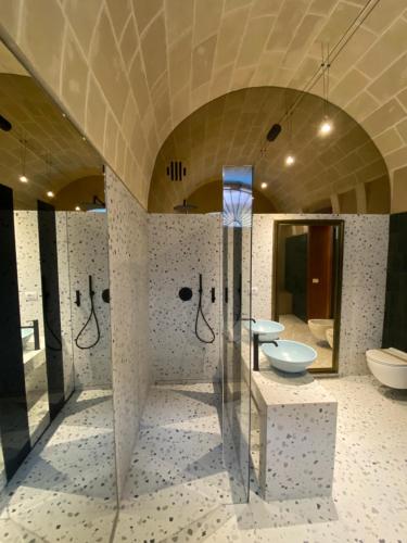 a large bathroom with two sinks and a mirror at La dimora di Don Antonio in Matera