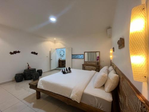 a bedroom with a large bed in a room at Lavender star house in Kuta