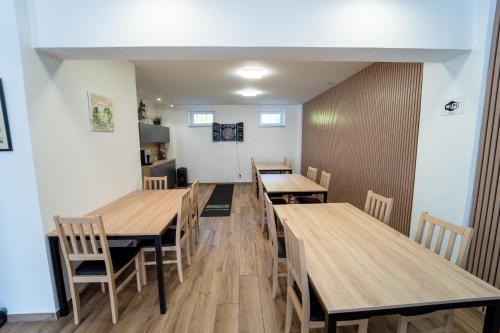 a dining room with wooden tables and chairs at Chata Markétka in Dobré