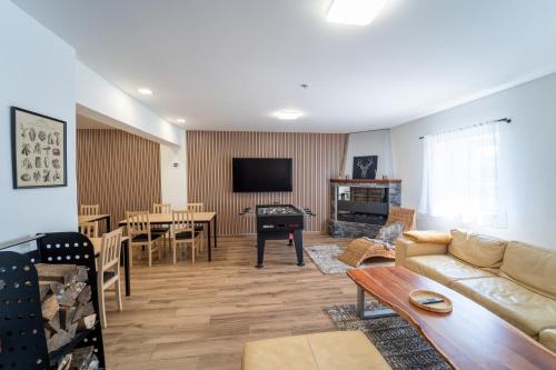 a living room with a couch and a dining room at Chata Markétka in Dobré