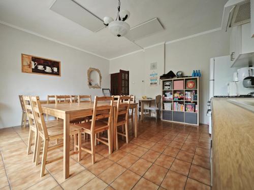 a kitchen and dining room with a table and chairs at Valley Vendégház in Eger