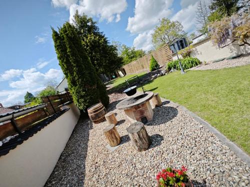 a garden with a bench and trees and flowers at Valley Vendégház in Eger