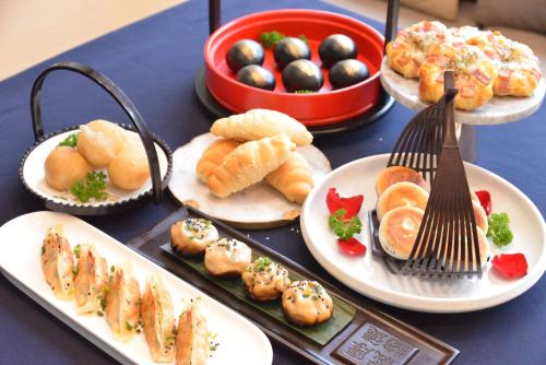 a blue table with plates of food on it at Le Meridien Suzhou, Suzhou Bay in Suzhou
