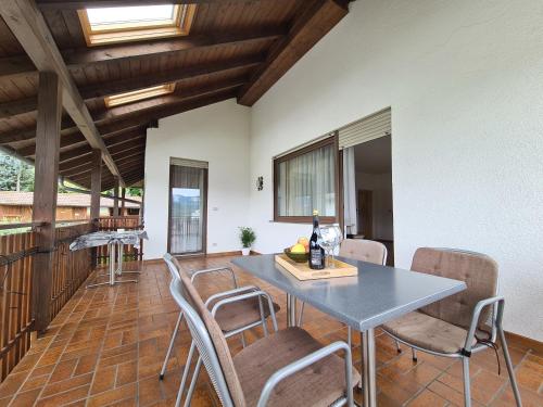 a dining room with a table and chairs at Urlaub auf dem Bauernhof Schmidhof - große Terrasse, Pool und beste Lage in Caldaro