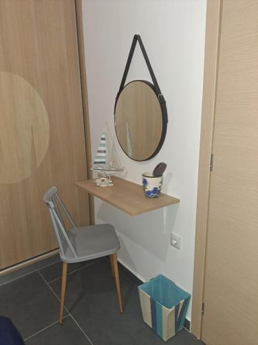 a dressing table with a mirror and a chair at A GEORGE Luxury house in Artemida