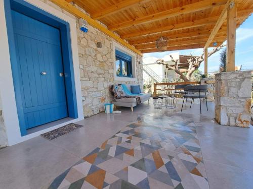 a large blue door on a house with a patio at A GEORGE Luxury house in Artemida