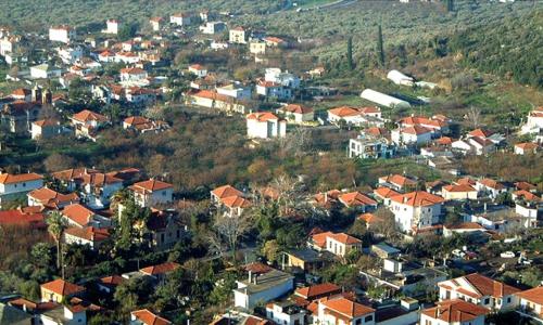 a small town with houses and buildings on a hill at Harmony Platanidia Pelion in Platanidia