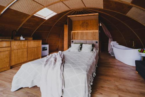 a bedroom with a large bed in a dome at Osada Marchowo in Kielno