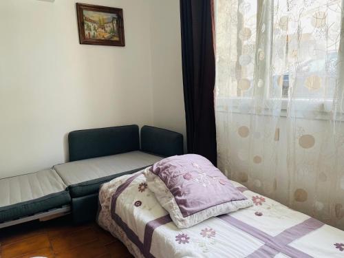 a small room with a bed and a window at Chez Marydidou : Chambres d'hôtes in Istres